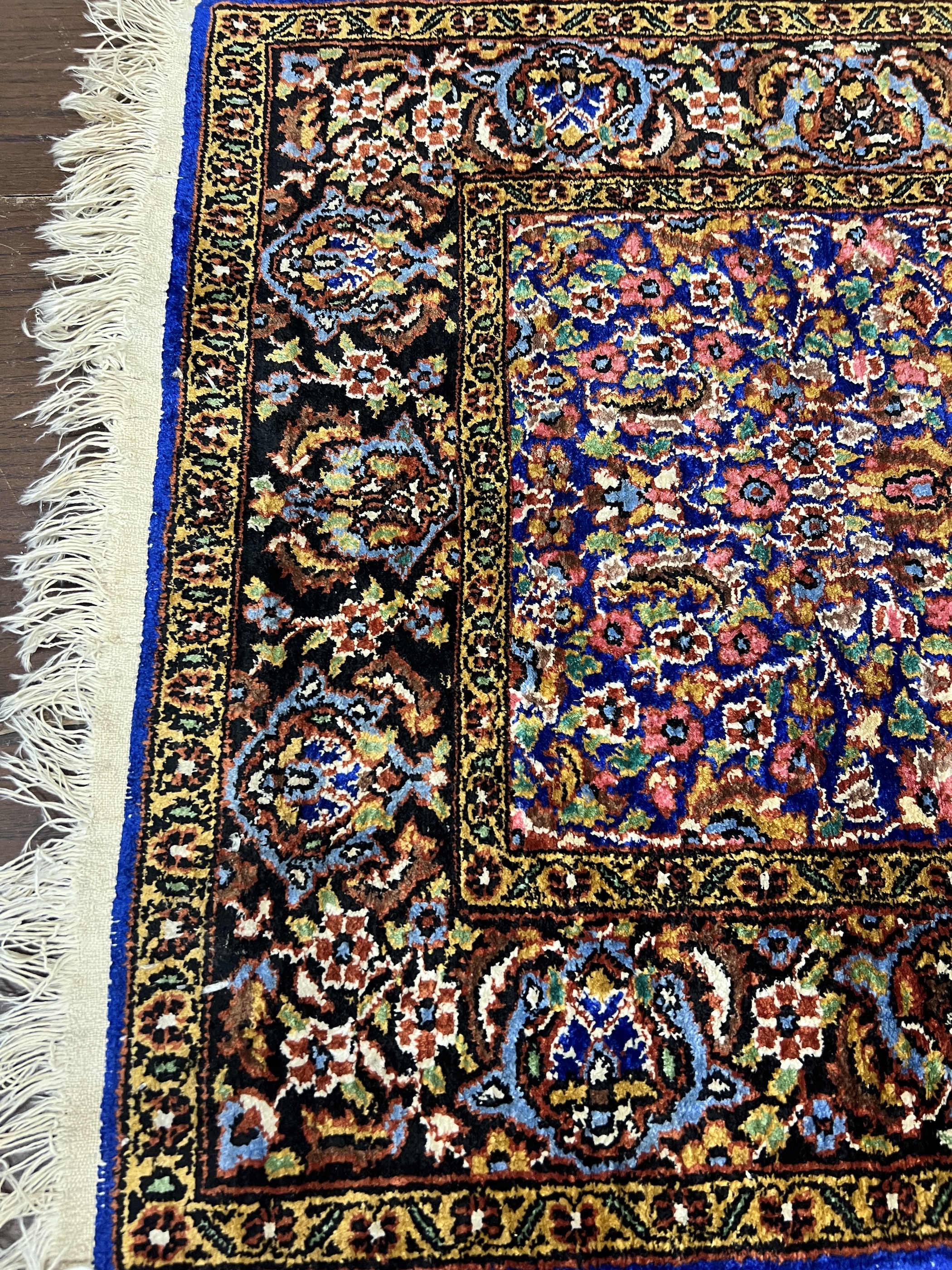 A North West Persian part silk blue ground rug, 89cm x 58cm